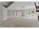 Spacious living room with lake view, carpet flooring, ceiling fans, and sliding glass door to the backyard at 11484 Lake Stonebridge Ln, Fishers, IN 46037