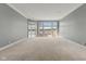 Expansive living room boasts large windows, flooding the space with natural light and offering beautiful water views at 11484 Lake Stonebridge Ln, Fishers, IN 46037