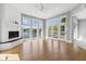 Bright living room features white brick fireplace and multiple windows offering picturesque lake views at 11484 Lake Stonebridge Ln, Fishers, IN 46037