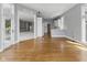 Open-concept living area with hardwood floors and bright lighting, seamlessly connecting to the kitchen with white cabinetry at 11484 Lake Stonebridge Ln, Fishers, IN 46037