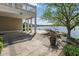 Outdoor patio with stone pavers and waterfront views and a wooden dock at 11484 Lake Stonebridge Ln, Fishers, IN 46037