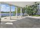 Covered patio with lake views, stone tiling, and wooden dock extending into the water at 11484 Lake Stonebridge Ln, Fishers, IN 46037