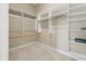 Well-organized walk-in closet with custom shelving and hanging space maximizes storage and provides easy access at 11484 Lake Stonebridge Ln, Fishers, IN 46037