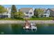 Waterfront home with dock, boat, and spacious backyard with lush landscaping overlooking the beautiful water at 11484 Lake Stonebridge Ln, Fishers, IN 46037