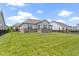 Expansive backyard with green grass, a fenced perimeter, and view of the house with large windows at 11595 Platt St, Noblesville, IN 46060