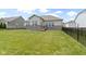 A well-maintained backyard with a green lawn, a brick and siding home, and a black metal fence at 11595 Platt St, Noblesville, IN 46060