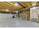 Unfinished basement featuring concrete floor, exposed beams, and staircase at 11595 Platt St, Noblesville, IN 46060