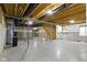 Unfinished basement featuring concrete floor, exposed beams, staircase, and utilities at 11595 Platt St, Noblesville, IN 46060
