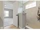 Modern bathroom with walk-in shower, tiled walls, glass panel and view from the bathroom into bedroom at 11595 Platt St, Noblesville, IN 46060