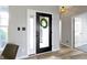Bright foyer featuring an open door, wood floors, neutral walls, and a view of the front porch at 11595 Platt St, Noblesville, IN 46060