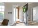 Bright foyer featuring an open door, wood floors, neutral walls, and a view of the front porch at 11595 Platt St, Noblesville, IN 46060