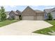 Inviting single story brick home with a manicured lawn and an attached three car garage at 11595 Platt St, Noblesville, IN 46060
