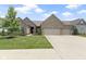 Inviting single story brick home with a manicured lawn and an attached three car garage at 11595 Platt St, Noblesville, IN 46060