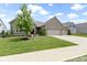 Well maintained single story brick home with a large front lawn and a three car garage at 11595 Platt St, Noblesville, IN 46060