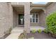 Inviting front porch with brick pillars, a black door, and nicely landscaped front yard at 11595 Platt St, Noblesville, IN 46060