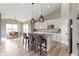 Bright kitchen with granite countertops, stainless appliances, island seating, and adjacent dining area at 11595 Platt St, Noblesville, IN 46060