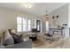 Spacious living room featuring high ceilings, modern furniture, wood floors, and neutral paint at 11595 Platt St, Noblesville, IN 46060