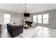Large living room showcasing hardwood floors, recessed lights, and an elegant fireplace at 11595 Platt St, Noblesville, IN 46060