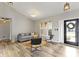 Inviting living room with modern furniture, wood floors, natural light, and a view of the foyer at 11595 Platt St, Noblesville, IN 46060