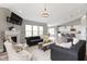 Bright living space showcasing an open floor plan, fireplace, and large windows allowing for ample natural light at 11595 Platt St, Noblesville, IN 46060
