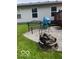 Landscaped backyard featuring a bench, outdoor fire pit, and well-maintained gray gravel at 11748 E 10Th St, Indianapolis, IN 46229