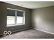 Bedroom with gray carpet and neutral gray walls at 11748 E 10Th St, Indianapolis, IN 46229