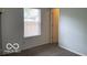 Bedroom with window and doorway to another room at 11748 E 10Th St, Indianapolis, IN 46229