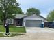 Charming single-story home with well-maintained lawn and attached two car garage at 11748 E 10Th St, Indianapolis, IN 46229