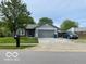 Charming single-story home with well-maintained lawn and attached two car garage at 11748 E 10Th St, Indianapolis, IN 46229