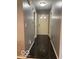 Inviting hallway with glossy tile flooring and neutral paint at 11748 E 10Th St, Indianapolis, IN 46229