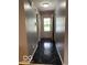 Inviting hallway with glossy tile flooring and neutral paint at 11748 E 10Th St, Indianapolis, IN 46229