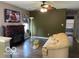 Cozy living room featuring a decorative fireplace and modern ceiling fan at 11748 E 10Th St, Indianapolis, IN 46229