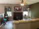 Cozy living room with a fireplace, tv, and ceiling fan at 11748 E 10Th St, Indianapolis, IN 46229