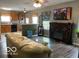 Cozy living room featuring a decorative fireplace and modern ceiling fan at 11748 E 10Th St, Indianapolis, IN 46229