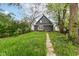 The back of the home leads to a long, narrow backyard with lush greenery, perfect for outdoor enjoyment at 1234 N Dearborn St, Indianapolis, IN 46201