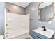 Bathroom with tub-shower combo, modern vanity, framed mirror, and sleek fixtures at 1234 N Dearborn St, Indianapolis, IN 46201