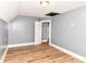 A carpetless bedroom with grey walls and white trim features a modern light fixture and open door at 1234 N Dearborn St, Indianapolis, IN 46201