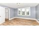Bedroom featuring wood-look floors and multiple windows at 1234 N Dearborn St, Indianapolis, IN 46201