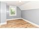 Bedroom with wood-look floors and window at 1234 N Dearborn St, Indianapolis, IN 46201