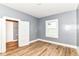 Spacious bedroom features wood-look floors, closet, and a window at 1234 N Dearborn St, Indianapolis, IN 46201