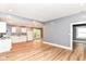 Open-concept kitchen with white appliances, wood floors, seamlessly connects to living space at 1234 N Dearborn St, Indianapolis, IN 46201