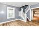 Inviting living space with a staircase, wood floors, and ample natural light for a welcoming atmosphere at 1234 N Dearborn St, Indianapolis, IN 46201