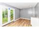 Bright, open living room with wood-look flooring and access to outdoor space through glass patio doors at 1234 N Dearborn St, Indianapolis, IN 46201