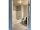 Full bathroom featuring a tub shower, a toilet, and light grey paint, creating a modern and sleek design at 12873 Tradd St # 2B, Carmel, IN 46032
