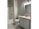 Bright bathroom featuring a tub-shower combo, toilet, and vanity with stylish sink and mirror at 12873 Tradd St # 2B, Carmel, IN 46032