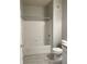 Clean bathroom featuring a white tiled shower-tub combo with a chrome showerhead and faucet at 12873 Tradd St # 2B, Carmel, IN 46032