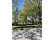 Landscaped community park featuring mature trees, manicured lawns, benches and walkways at 12873 Tradd St # 2B, Carmel, IN 46032