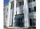 Exterior angle of the Fordham House entrance, featuring white architectural pillars and a blue entrance door at 12873 Tradd St # 2B, Carmel, IN 46032