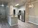 Bright kitchen featuring stainless steel appliances, white cabinets, and modern light fixtures at 12873 Tradd St # 2B, Carmel, IN 46032