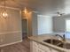 Open kitchen featuring stone countertops and a stainless steel double sink at 12873 Tradd St # 2B, Carmel, IN 46032